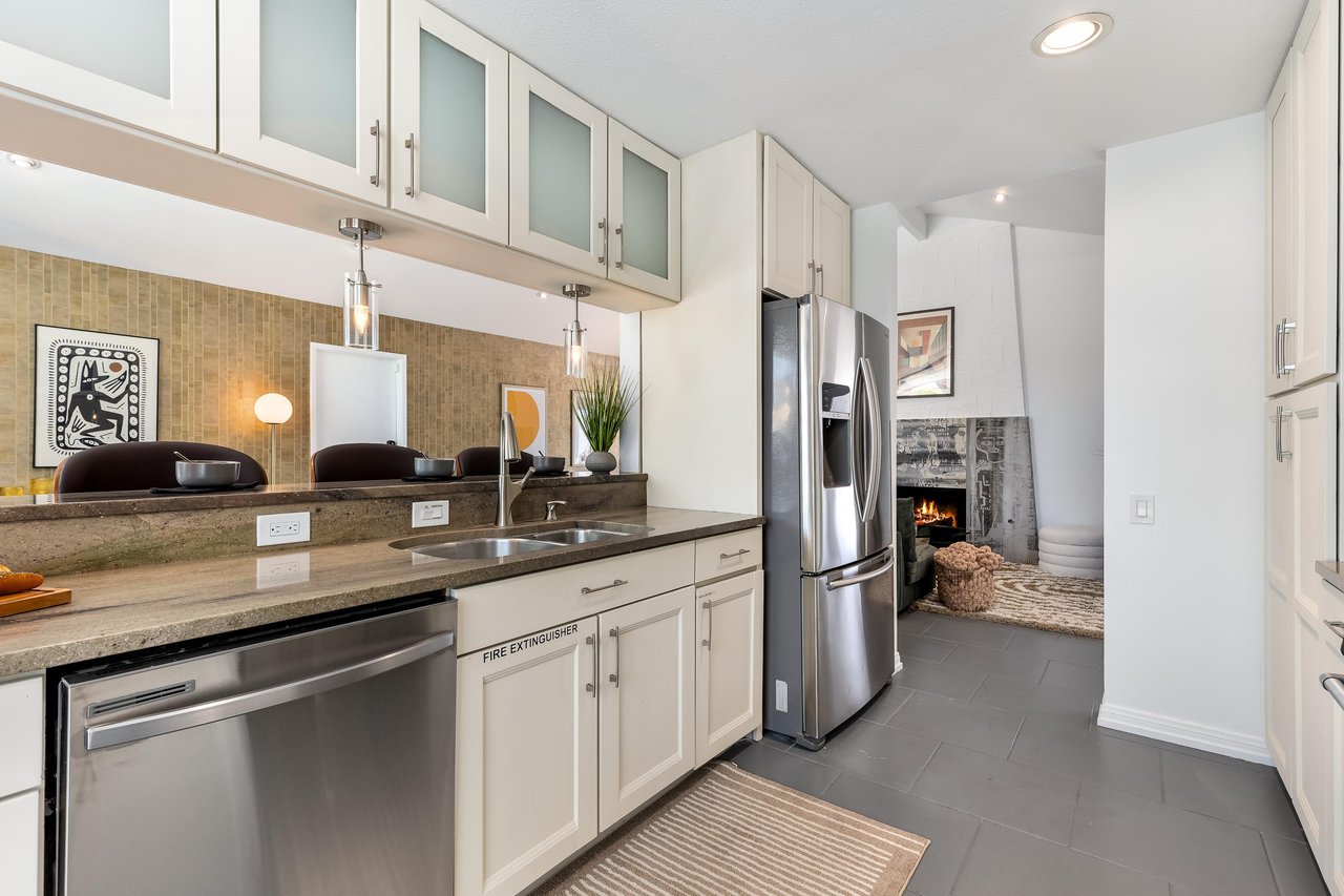 Lovely white cabinets host many culinary amenities