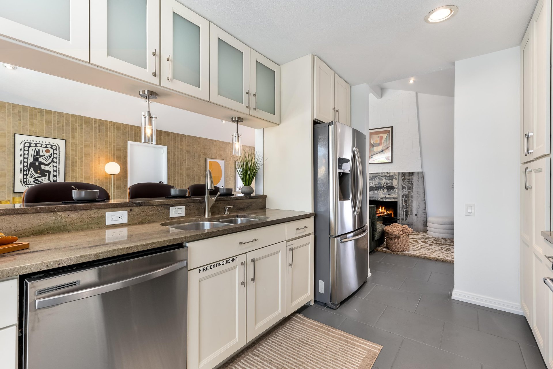 Lovely white cabinets host many culinary amenities