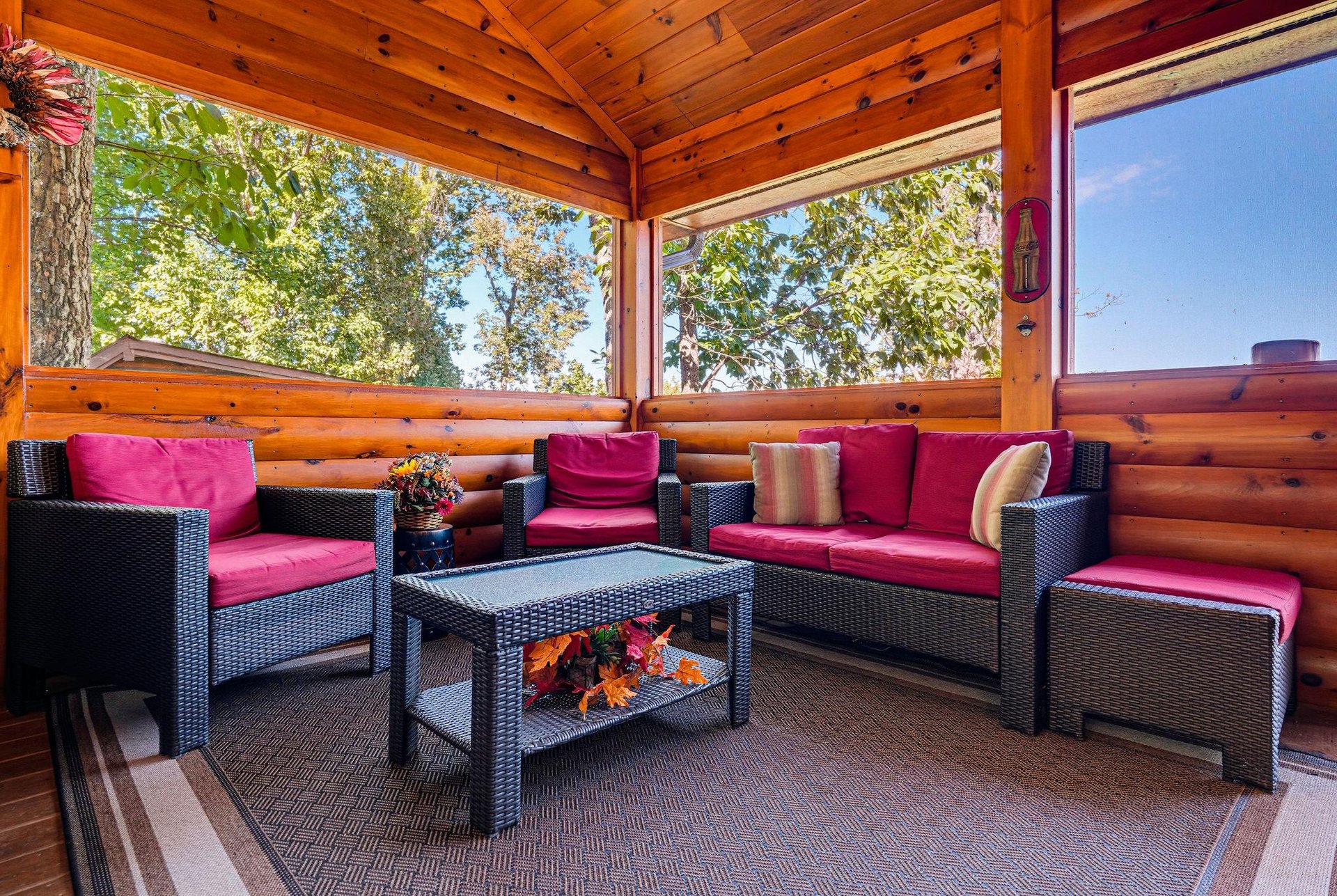Unwind in your screened porch with vibrant cushioned seating and tranquil views of surrounding greenery, perfect for morning coffee or evening relaxation.