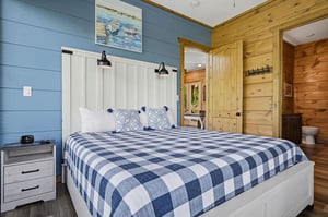 Drift off in coastal comfort with crisp linens, charming nautical touches, and warm wood accents creating your perfect lakeside retreat.