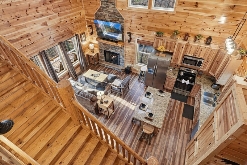 Enjoy your mountain retreats stunning openconcept design with soaring ceilings, stone fireplace, and fully equipped kitchen perfect for cozy evenings.