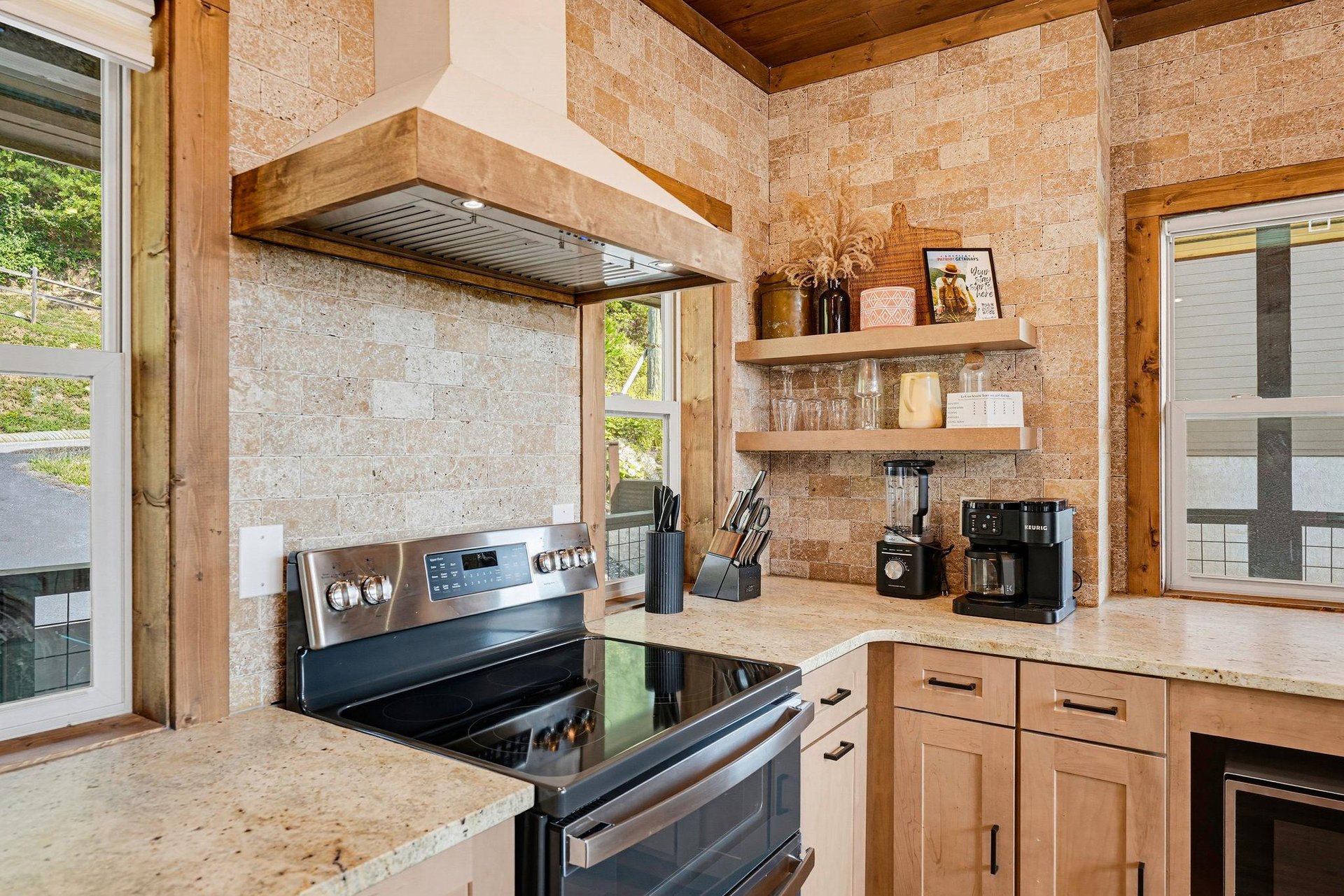 Step into a warm, modern kitchen where natural stone and wood beams create a cozy, rusticchic vibe. Everything you need to prepare a delicious homecooked meal awaits, with open shelves and counterto
