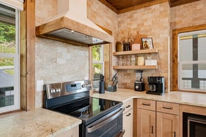 Step into a warm, modern kitchen where natural stone and wood beams create a cozy, rusticchic vibe. Everything you need to prepare a delicious homecooked meal awaits, with open shelves and counterto