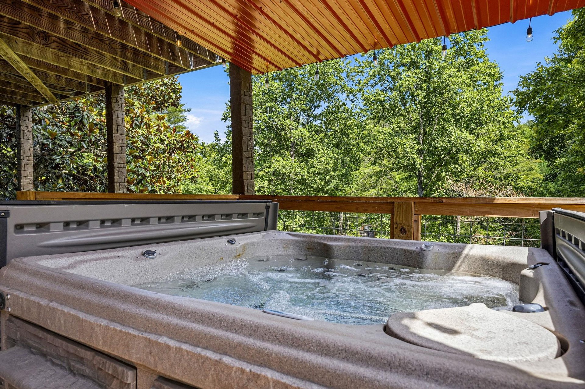 Soak in your private hot tub on the covered deck while surrounded by lush forest views. Feel the gentle breeze and listen to rustling leaves as warm bubbles melt away your stress.