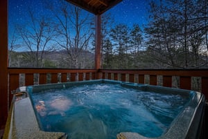 Soak in your private hot tub while stargazing above the forest canopy—pure mountain magic awaits on your covered deck.