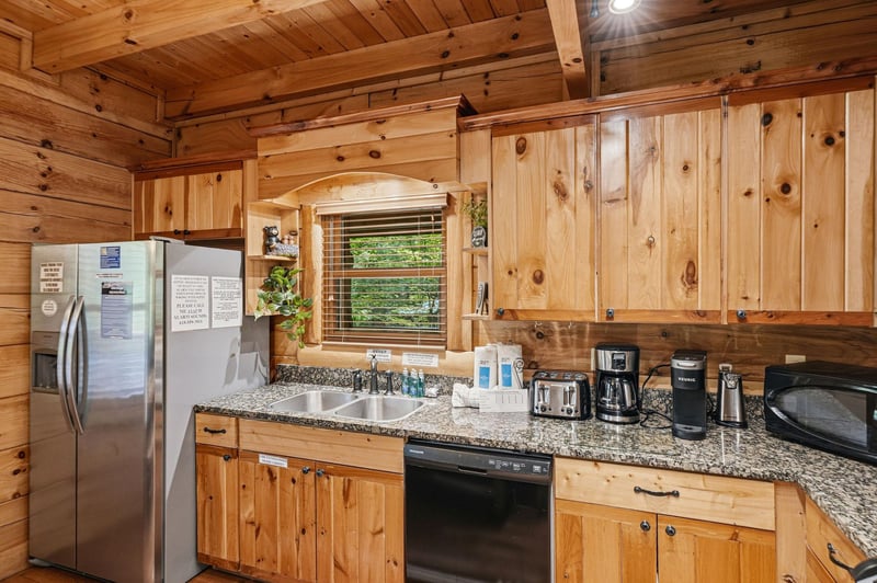 Step into your fullyequipped mountain kitchen, where rustic knotty pine cabinets and modern appliances blend perfectly for your homeawayfromhome retreat.