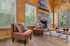 living room with 2 chairs, fireplace and TV