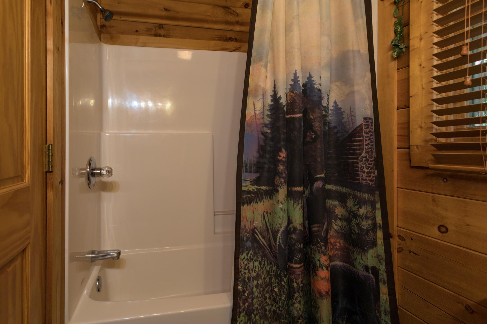 bathroom with a tub and shower at angels majestic view a 3 bedroom cabin rental located in pigeon forge