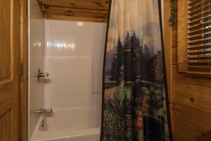 bathroom with a tub and shower at angels majestic view a 3 bedroom cabin rental located in pigeon forge
