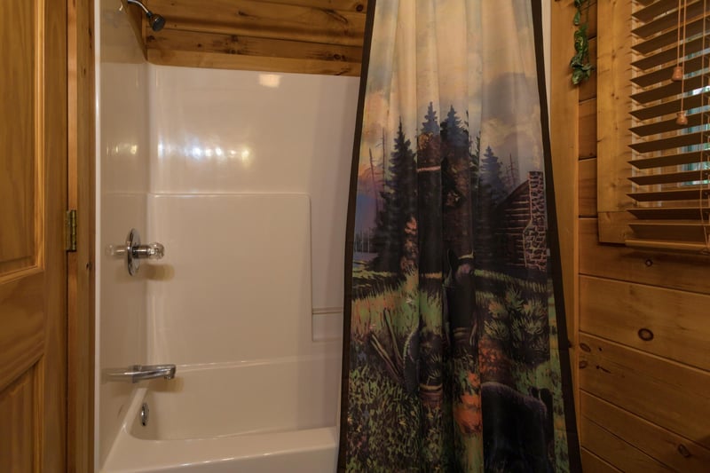 bathroom with a tub and shower at angels majestic view a 3 bedroom cabin rental located in pigeon forge