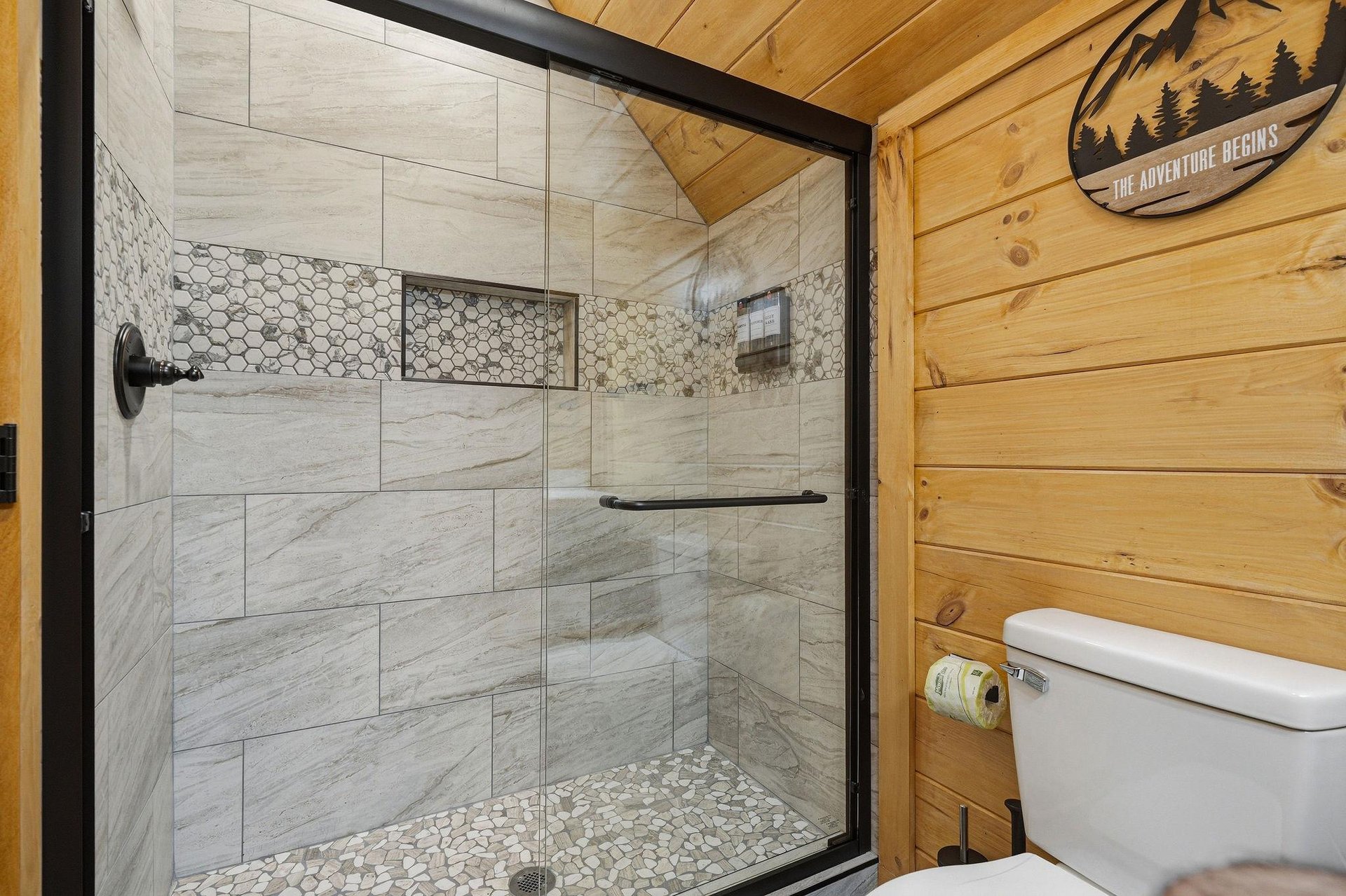 Step into your beautifully appointed bathroom featuring a stunning marbletiled shower with decorative hexagon accents.