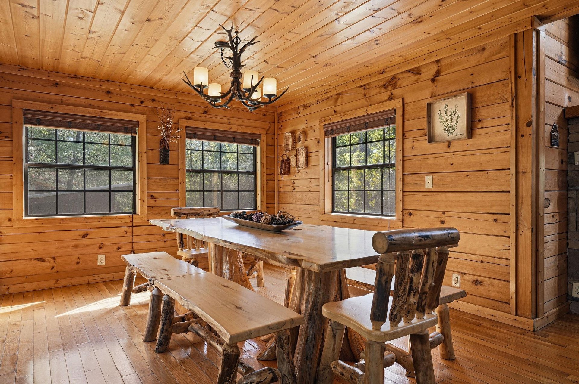 Gather around this handcrafted log dining table where rustic charm meets modern comfort in your mountain retreat.