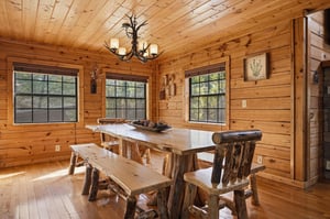 Gather around this handcrafted log dining table where rustic charm meets modern comfort in your mountain retreat.