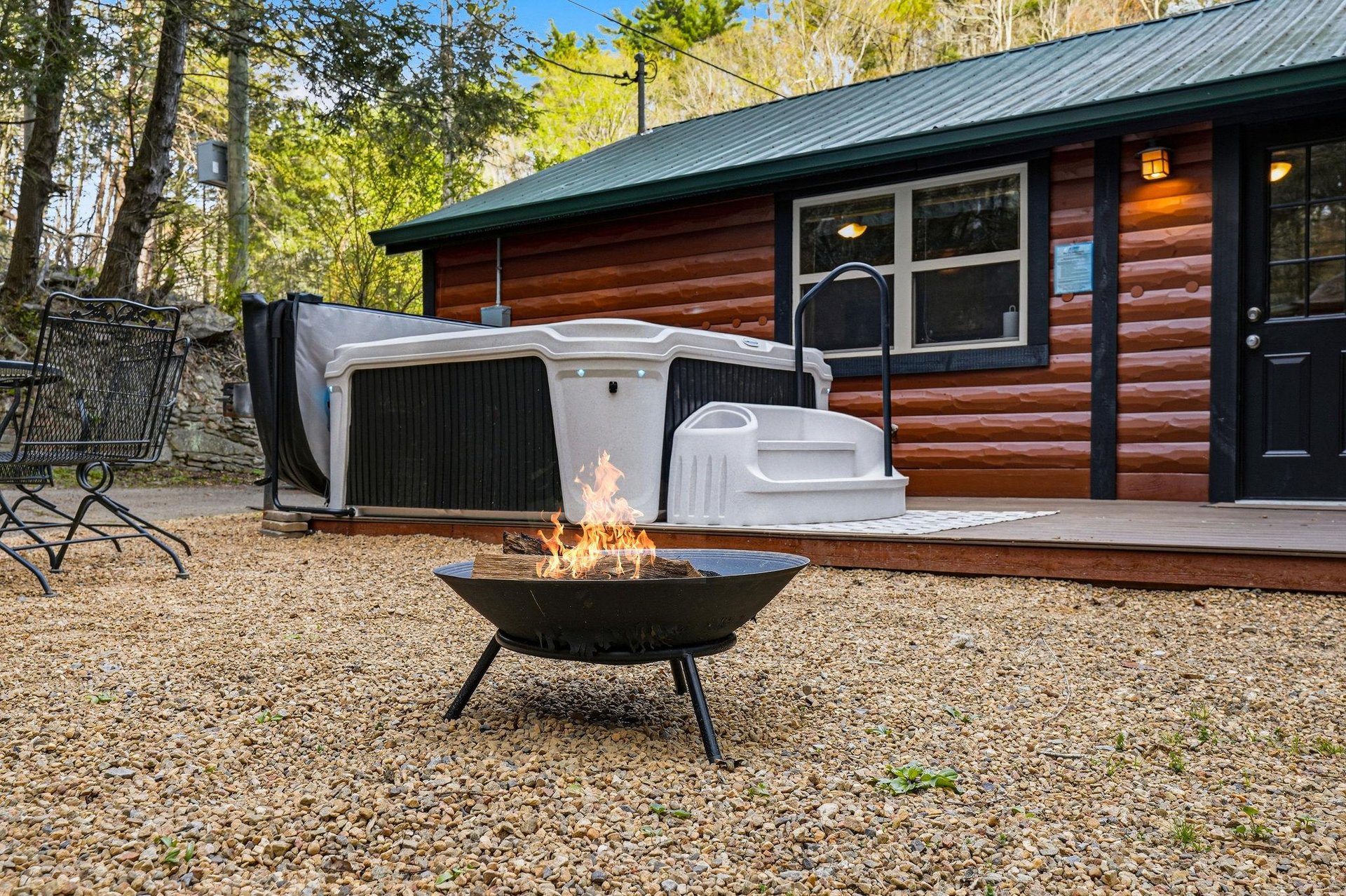 Unwind by your private fire pit and hot tub after exploring nature trails, with cozy cabin warmth awaiting you inside.