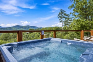 Soak in your private hot tub while taking in sweeping mountain views—pure bliss under open skies and endless green peaks.