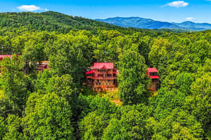 A charming mountain retreat nestled in lush forest with stunning views of the surrounding peaks and valleys.