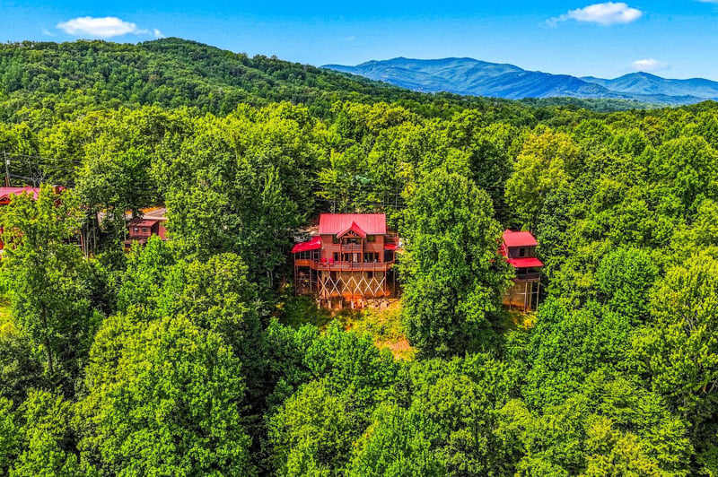 A charming mountain retreat nestled in lush forest with stunning views of the surrounding peaks and valleys.