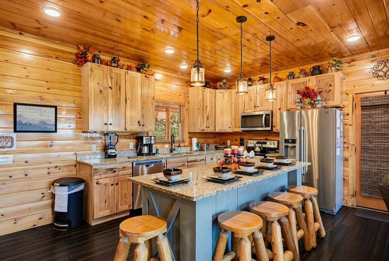Your fully equipped kitchen offers granite countertops, stainless appliances, and warm wood accents—perfect for preparing meals together after a day of exploring the Smokies.