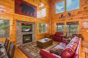 Living room with fireplace and TV at Graceland, a 4bedroom cabin rental located in Pigeon Forge