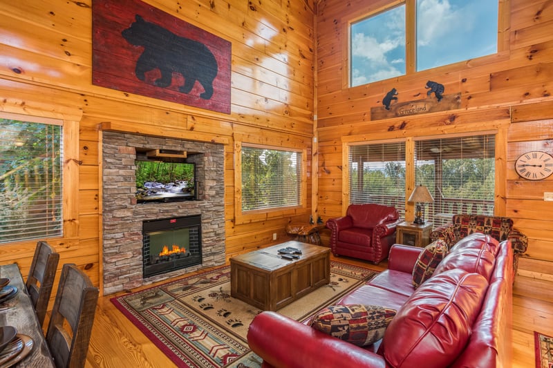 Living room with fireplace and TV at Graceland, a 4bedroom cabin rental located in Pigeon Forge