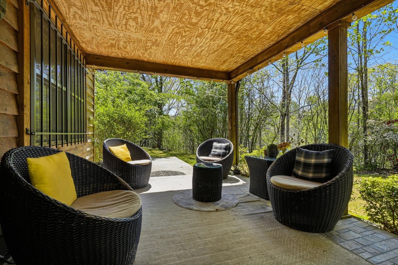 Relax in your private covered terrace surrounded by lush greenery, with comfortable wicker seating perfect for morning coffee or evening conversations.