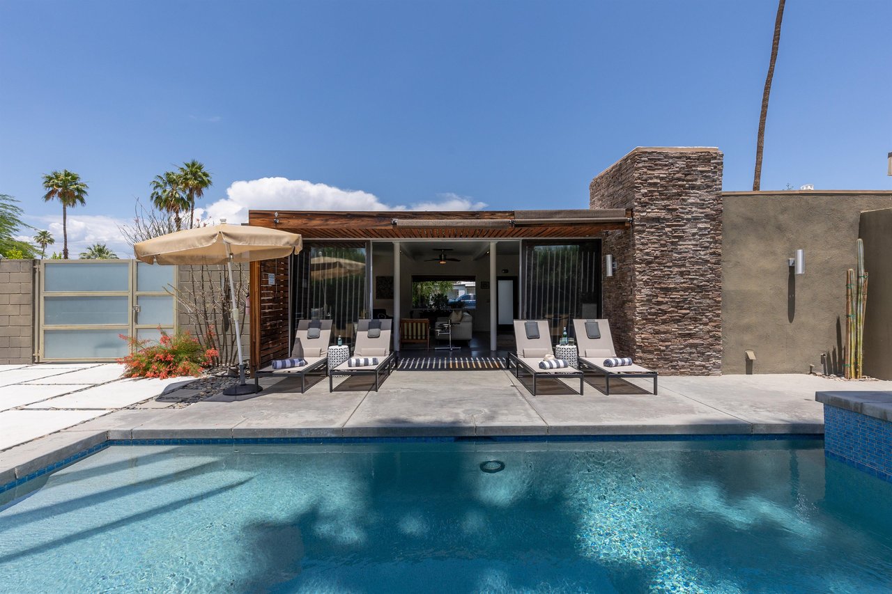 Loungers in front of glistening pool