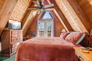 Bed, Dresser and TV in the bedroom at Living on Love, a 2 bedroom cabin rental located in Pigeon Forge