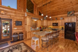 Kitchen with island and counter seating at Great View Lodge, a 5bedroom cabin rental located in Pigeon Forge