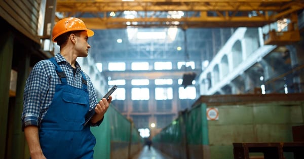 Master looks at work of crane operator on factory