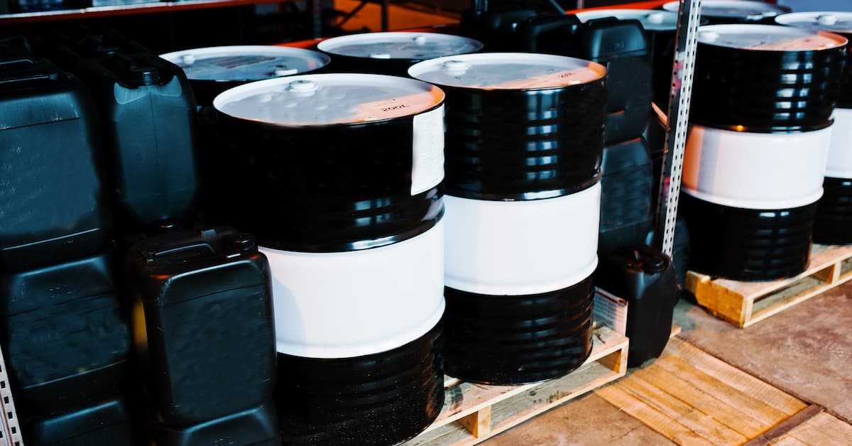 Barrels and cans of lubricant on shelves