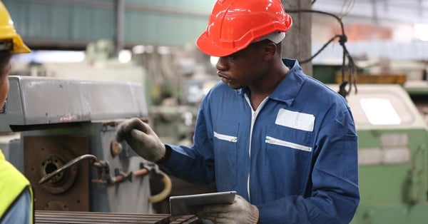 Industrial factory employee working in metal manufacturing