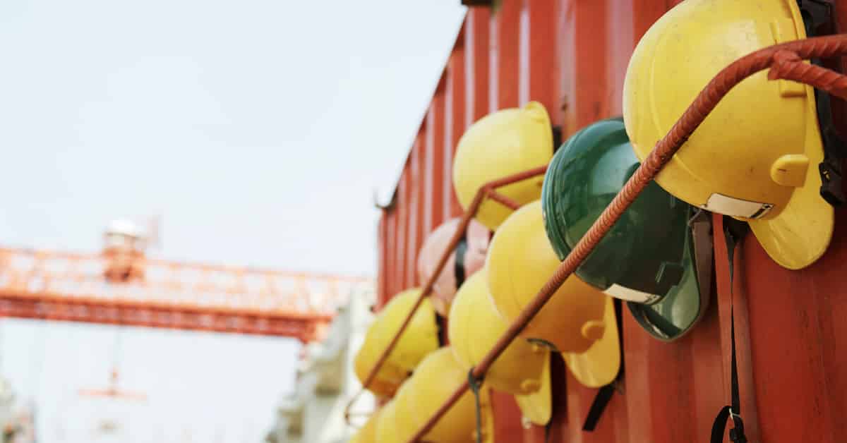 Closeup of a variety of safety helmets in a row at a construction site