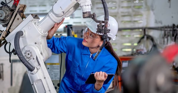 Asian factory worker woman holding tablet for maintenance