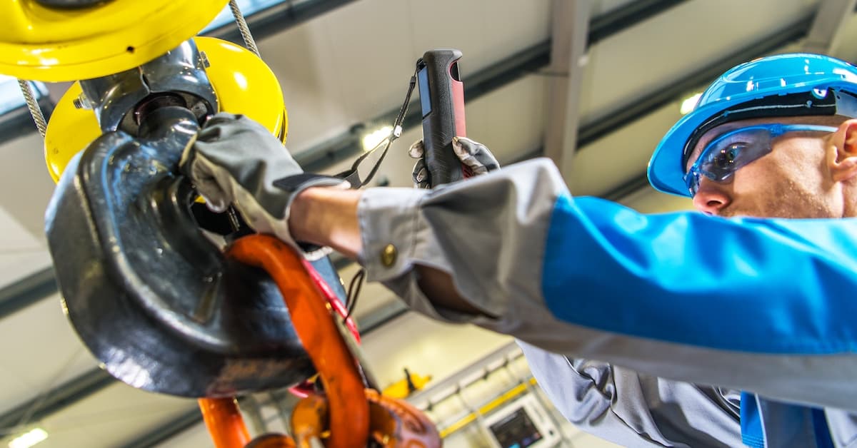 Warehouse crane operator performing autonomous maintenance