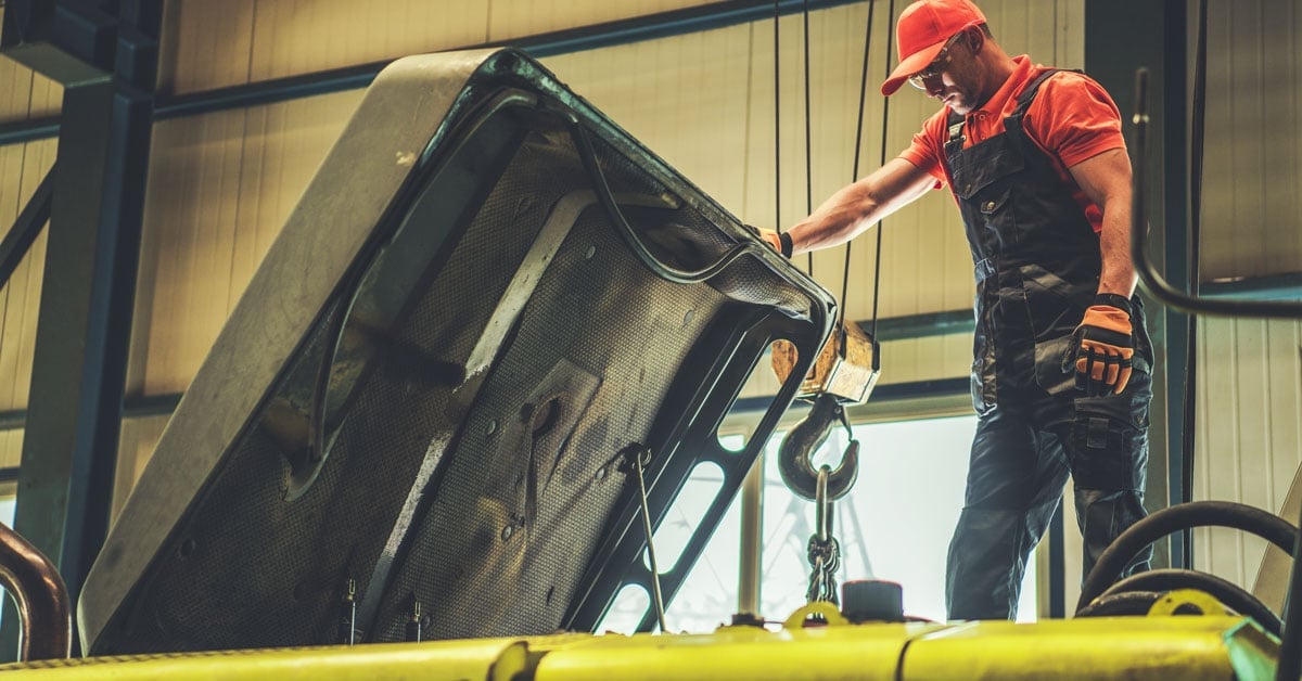 Mechanic repairing excavator