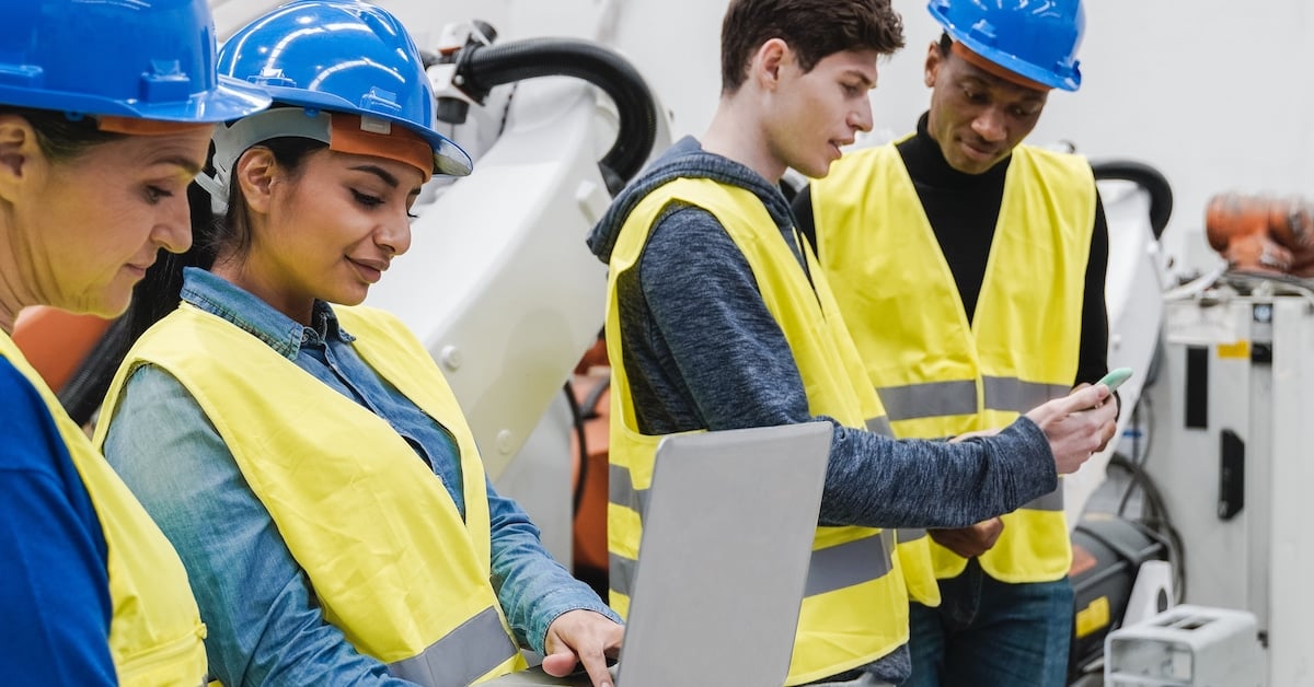 Multiracial industrial engineers working at automation facility