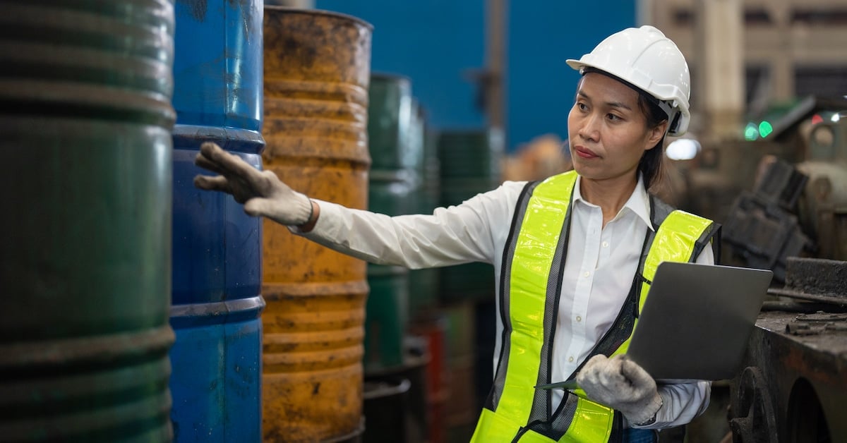 Asian female engineer in vest and helmet