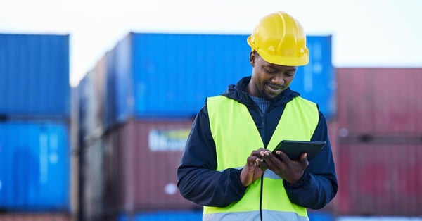 Logistics professional with digital tablet in supply chain setting