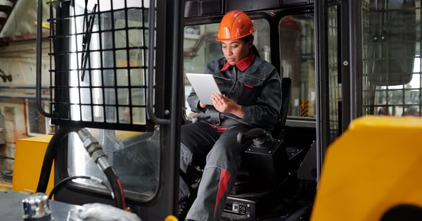 Young busy worker of factory scrolling on tablet