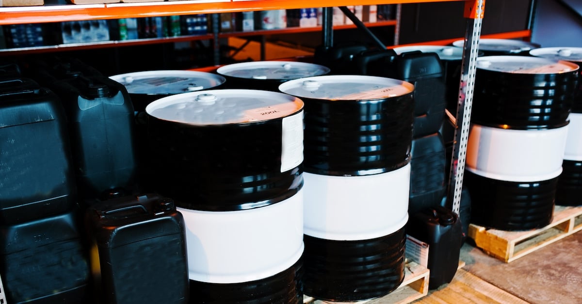 Barrels and cans of motor oil on shelves