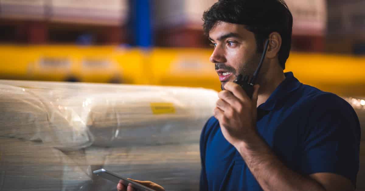 Male dispatcher warehouse worker checking package