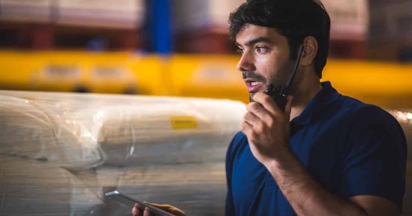 Male dispatcher warehouse worker checking package