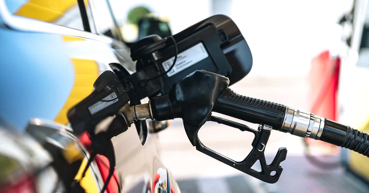 Pumping gasoline fuel in car at gas station