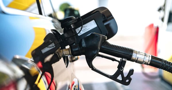 Pumping gasoline fuel in car at gas station