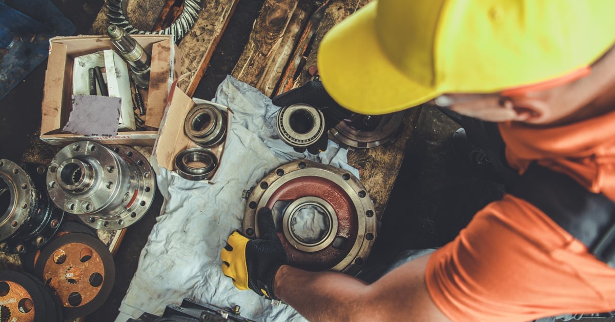 Professional machinery mechanic working on spare parts management