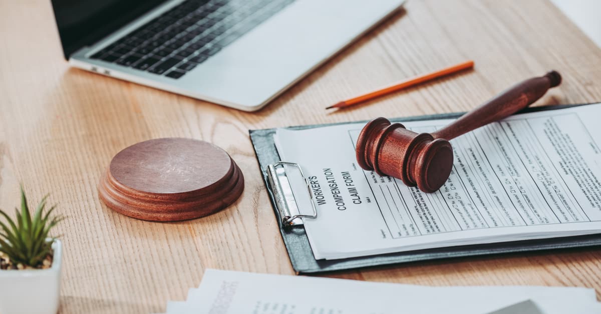Clipboard with compensation claim form and gavel