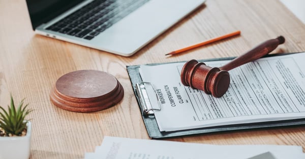 Clipboard with compensation claim form and gavel