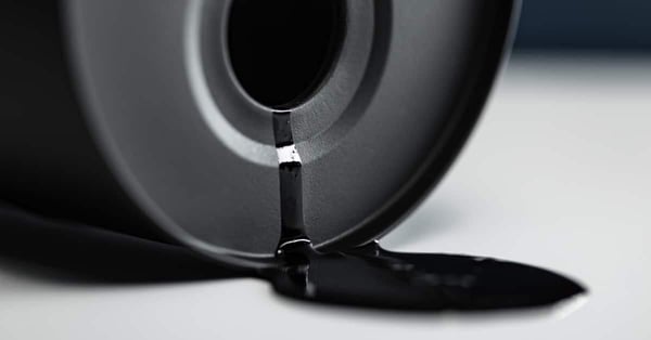 Oil industry concept - spilled oil from a mini barrel
