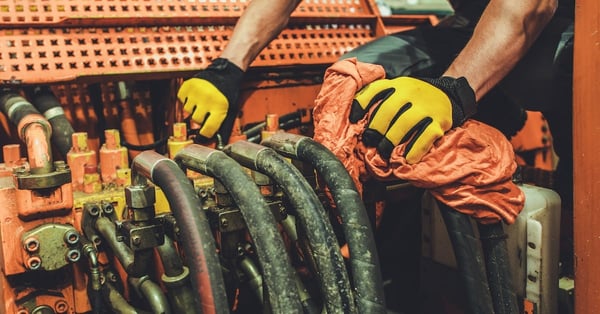 Heavy machinery mechanic performing pneumatic system maintenance