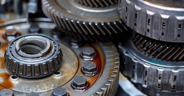 Close up of helical gears with oil lubrication